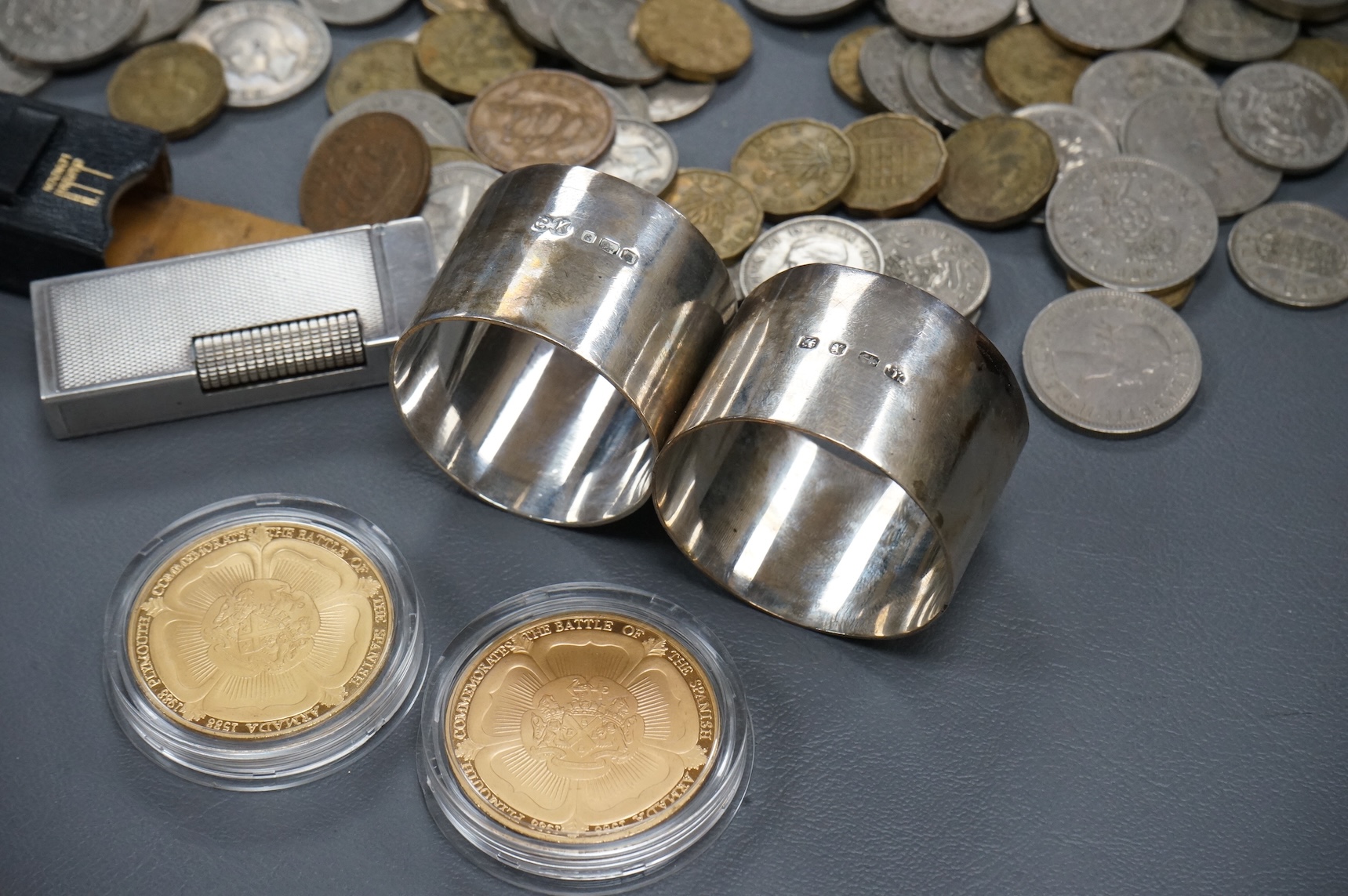 Sundry items comprising a cased Dunhill lighter, coins and napkin rings